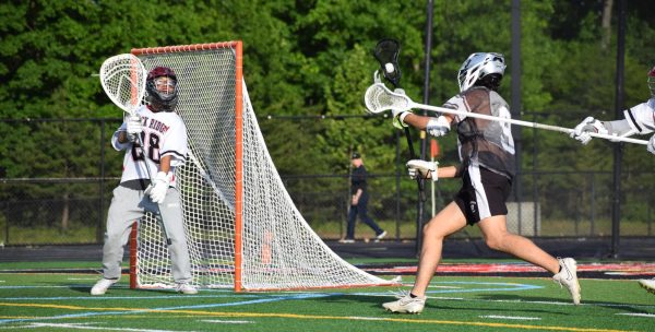 Senior David Cheong attempts to stop the Dominion Titans from scoring a goal.