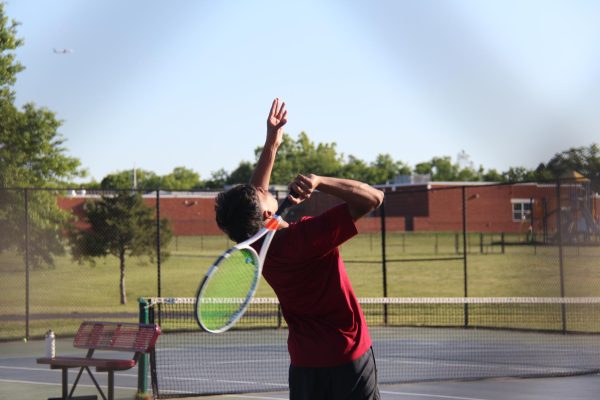 Senior Sreeram Gourineni tosses the ball high in preparation to serve.