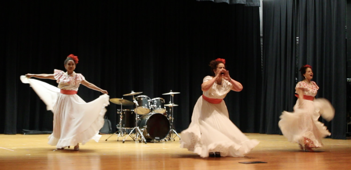Three participants showcase their Puerto Rican culture by traditional dance, filling the auditorium with high energy and lots of applause.