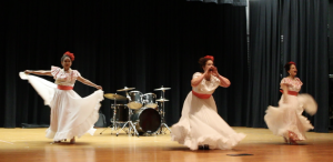Three participants showcase their Puerto Rican culture by traditional dance, filling the auditorium with high energy and lots of applause.