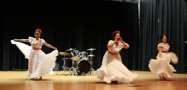 Three participants showcase their Puerto Rican culture by traditional dance, filling the auditorium with high energy and lots of applause.