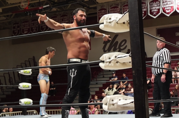 Wrestler Rex Lawless celebrates a successful takedown during the main title fight. 
